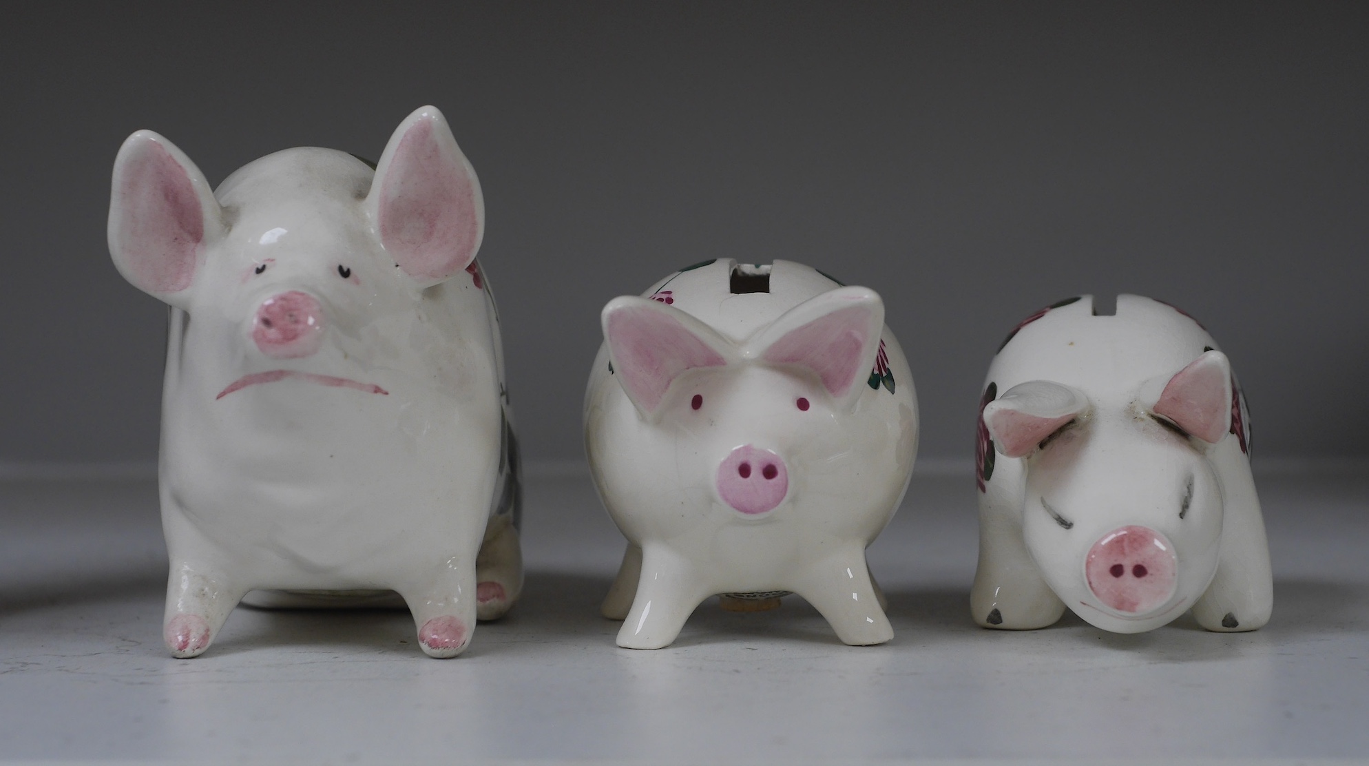 Three Plichta ‘pig’ ceramic money banks, each stamped to the bases, largest 16cm wide. Condition - fair